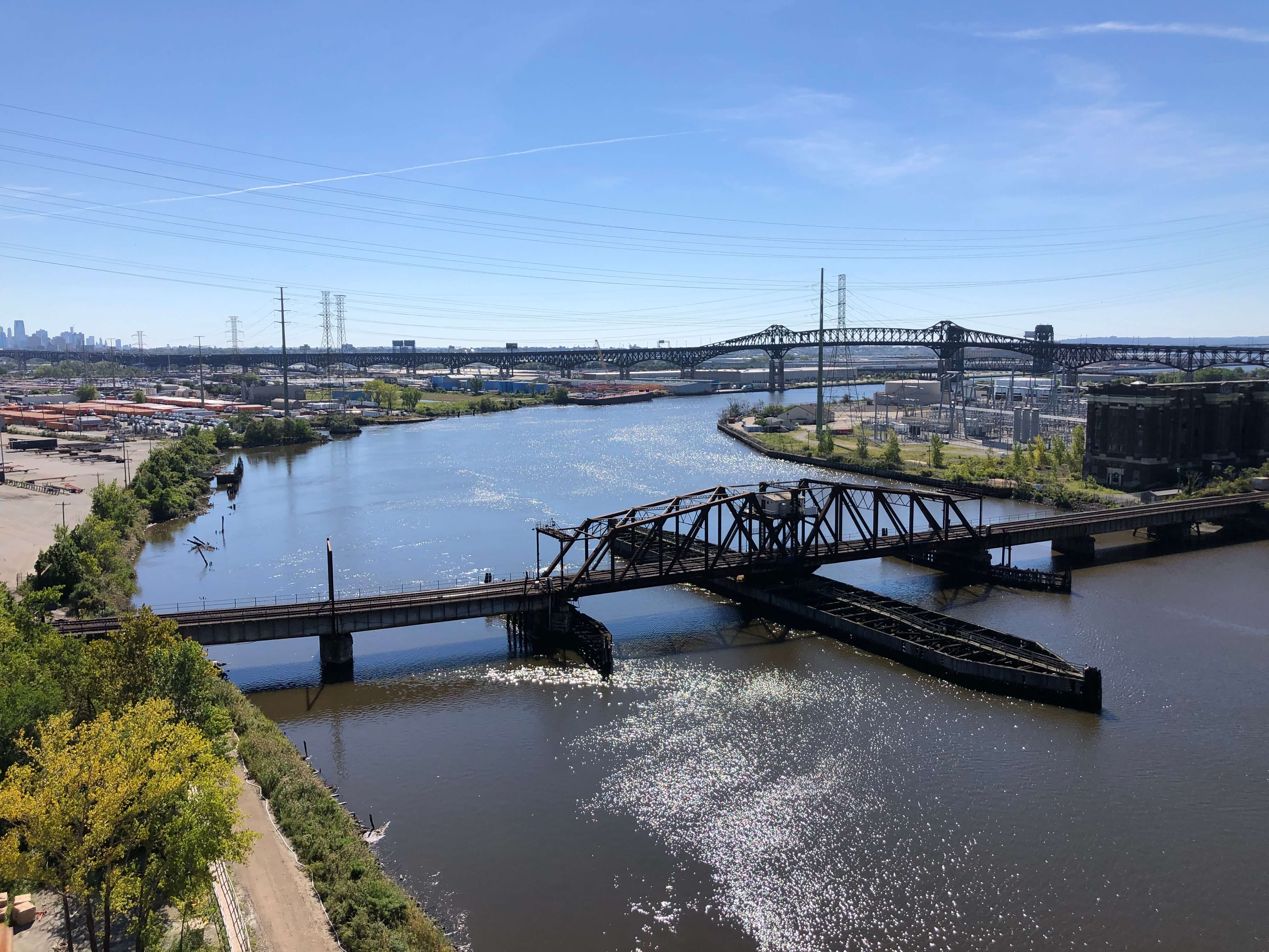 The old Point-no-Point swint-type railroad bridge is visible in the foreground over the Passaic River in Newark, New Jersey.